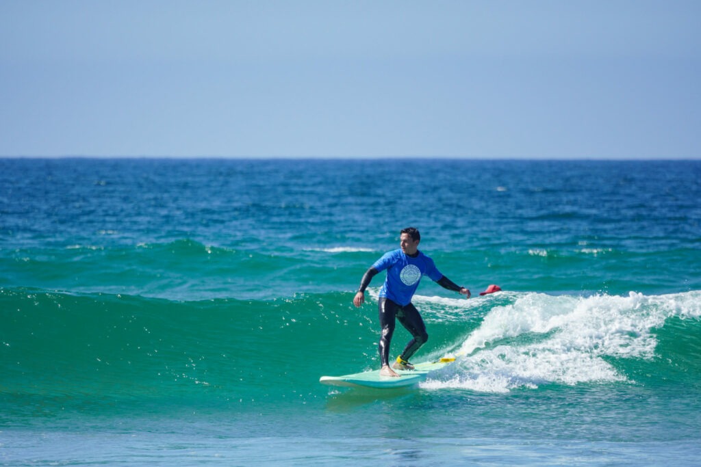 Person riding the waves on a private surf lesson in San Diego.