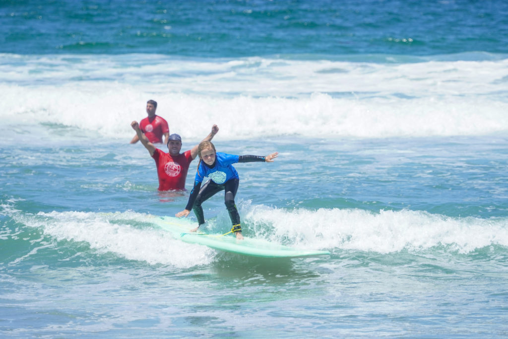 Surf instructors at Pacific Surf School teaching young kid how to surf