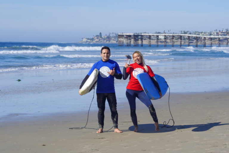 Two surfers learning to surf in San Diego