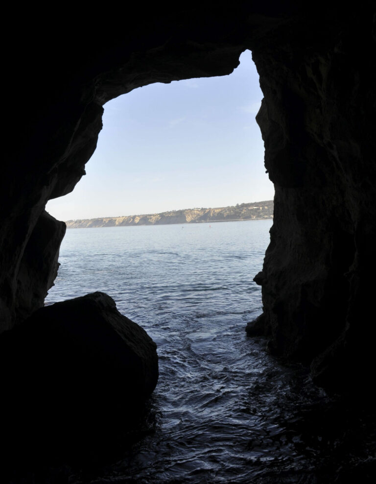 Silhouette cave opening shaped like a face.