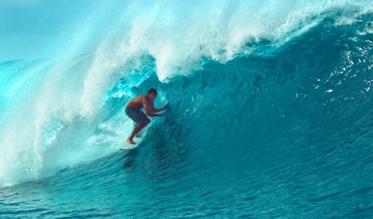 Man surfing big wave in Hawaii