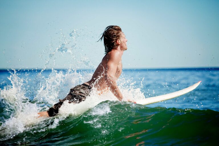 Man getting ready to pop up on a surfboard