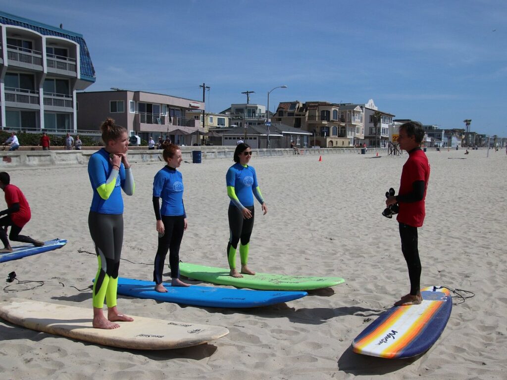 Pacific Surf School instructor teaching a group of kids how to surf.