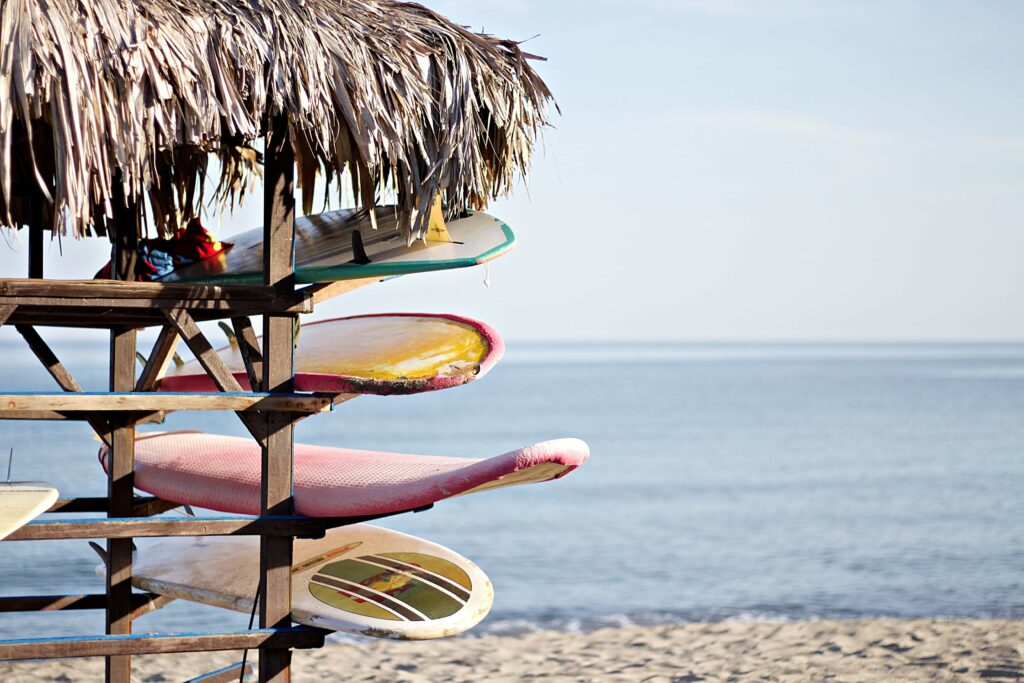 A rack holding a variety of different types of surfboards.