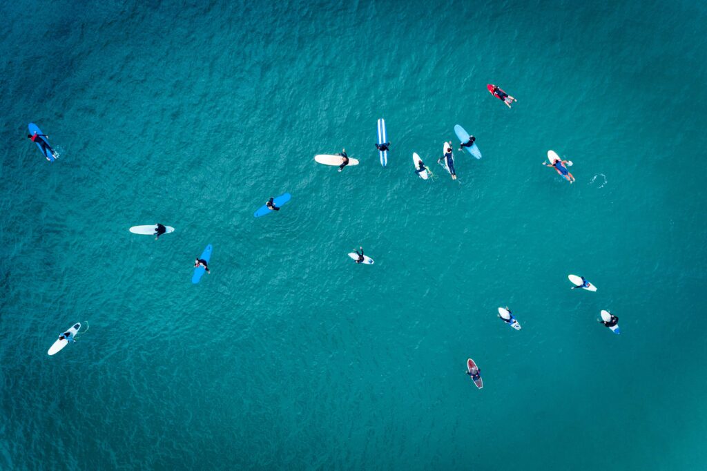 Aerial shot of a group of surfers waiting to catch the next wave.
