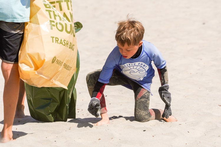 Child participating in a beach clean-up action