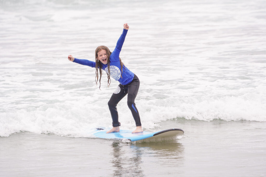 Happy child learning to surf