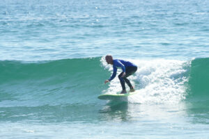 A man surfing and honing his surfing skills
