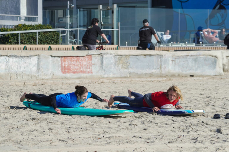 Student and instructor in a surfing class