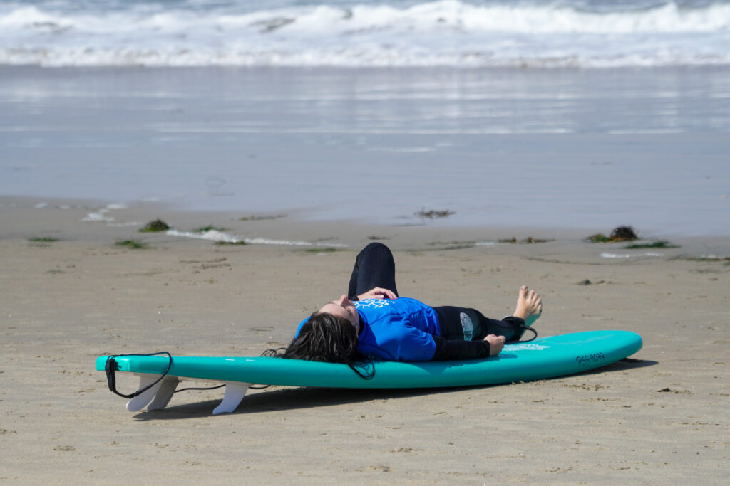 Surfer lying on the surfboard and relaxing
